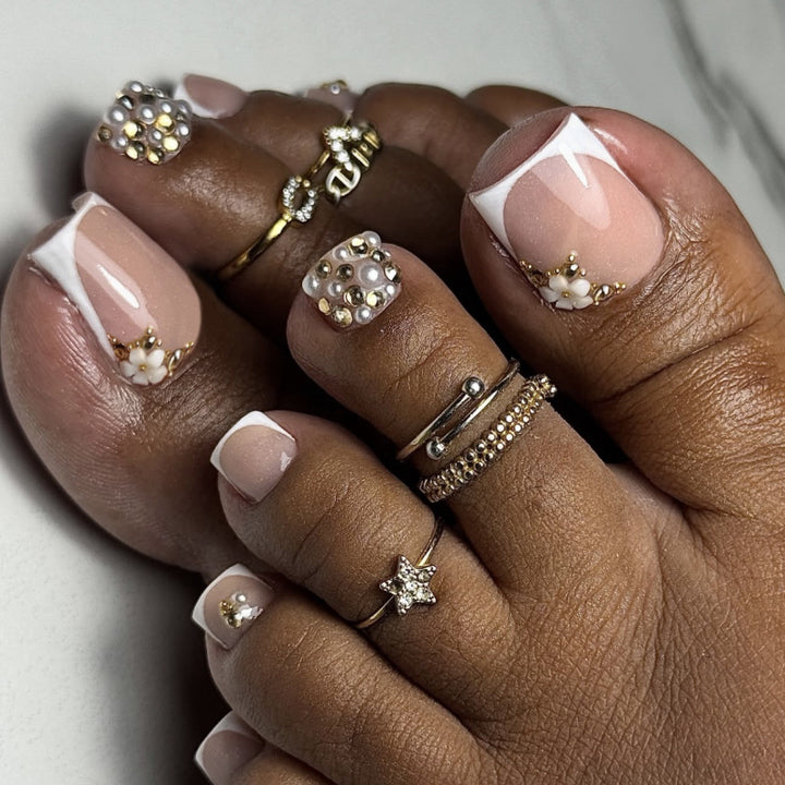 Glamorous toenail art with luxurious rhinestone and floral designs Stornfield