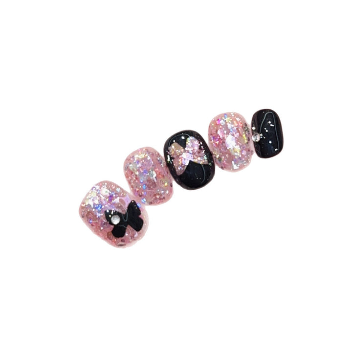 Artificial nails with glitter and bow accents Stornfield