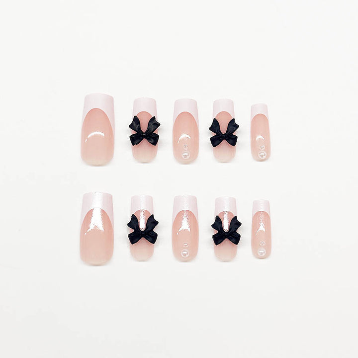 Acrylic nail set with stylish black and pearl details Stornfield