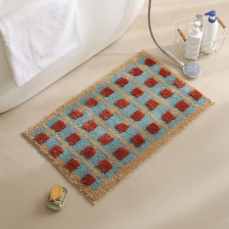 Hand-tufted bathroom bath mat with non-slip backing and textured square relief Stornfield