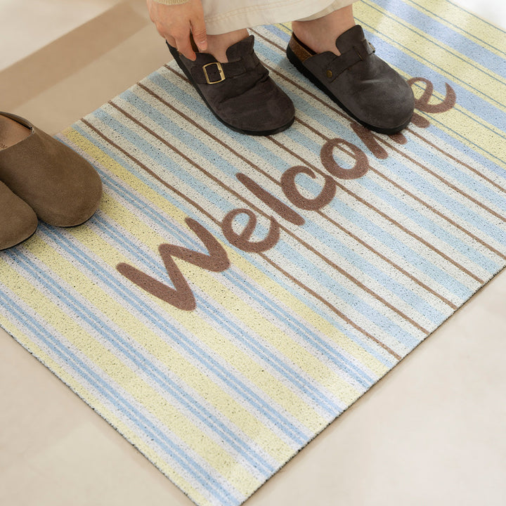 Durable entrance doormat with striped texture and "Welcome" lettering Stornfield