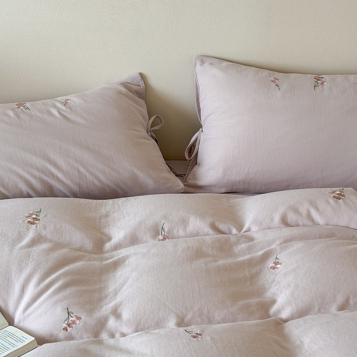Embroidered cotton bedding set with delicate floral embroidery and tie bands