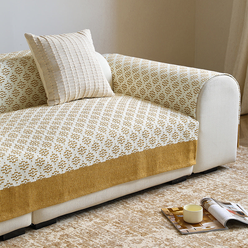 Knitted sofa cover with jacquard pattern and reinforced hem border Stornfield