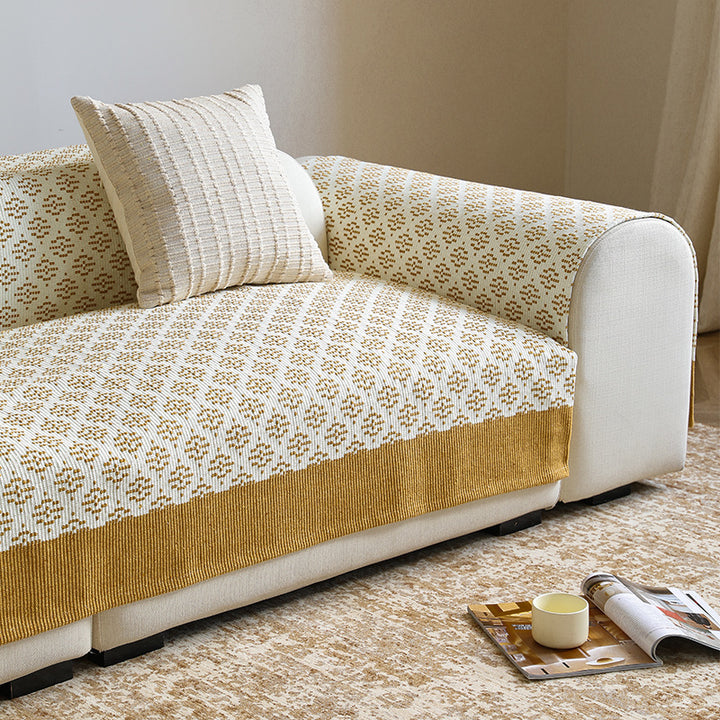 Knitted sofa cover with jacquard pattern and reinforced hem border Stornfield