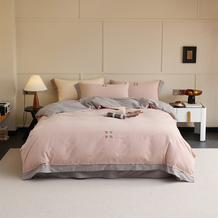 Luxurious cotton satin bedding set with contrasting piped edge and monogram embroidery