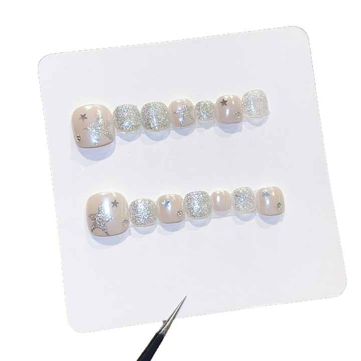 Glamorous artificial nails with sparkling stars and glitter accents Stornfield