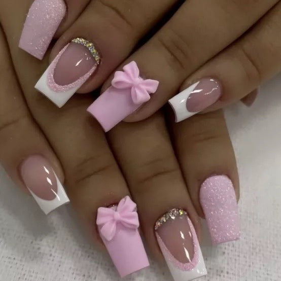 Artificial nail set with playful bows and glitter accents Stornfield