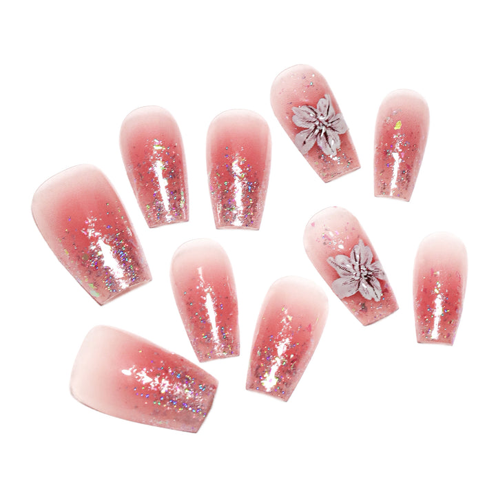 Artificial nail extensions with floral design and glitter accents Stornfield