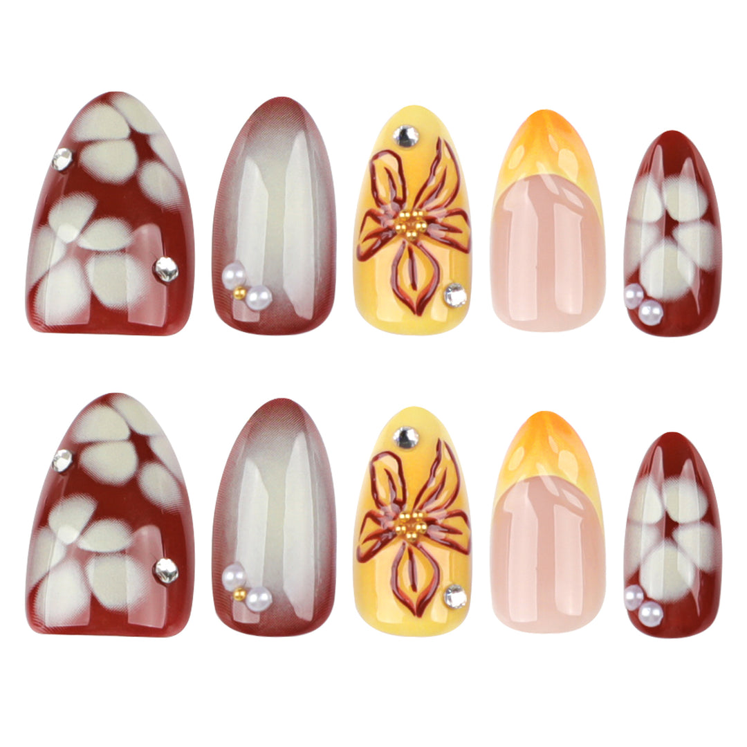 Artificial nail extensions with floral design and rhinestone embellishments Stornfield