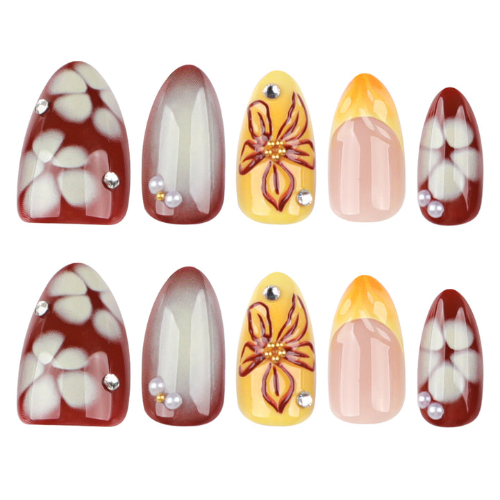 Artificial nail extensions with floral design and rhinestone embellishments Stornfield