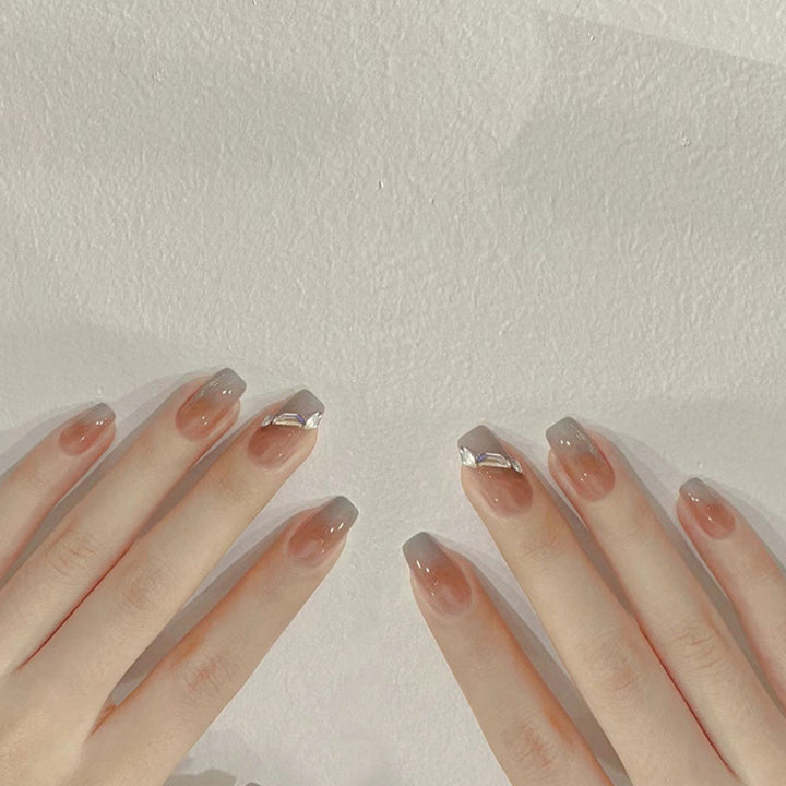 Artificial nail set with elegant ombre design and sparkling applications Stornfield