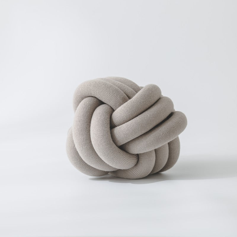 Decorative knitted knot cushion as a decorative pillow made of soft jersey