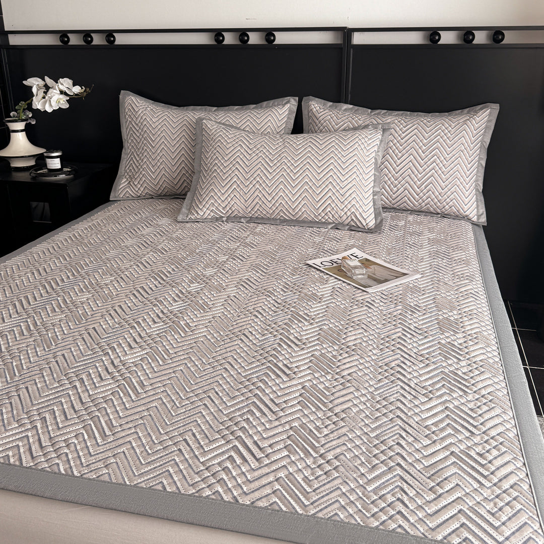Quilted bedspread and pillow set with geometric striped quilting