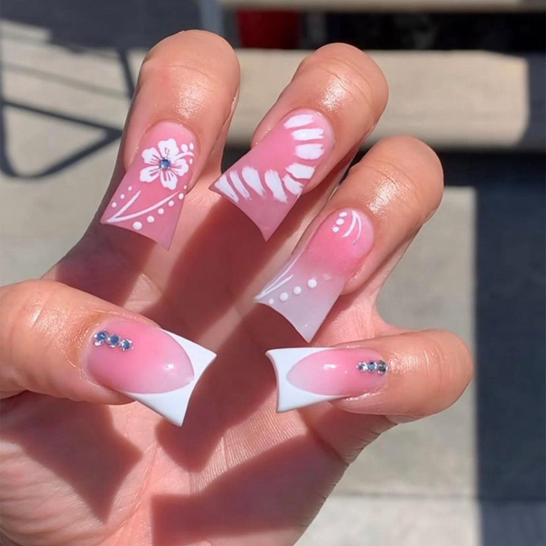 Acrylic nail set with elegant floral designs and glitter accents Stornfield
