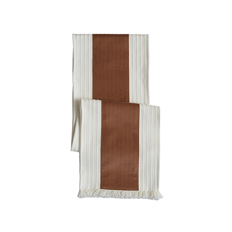 Woven table runner with contrasting center stripe, textured waffle look and decorative fringes