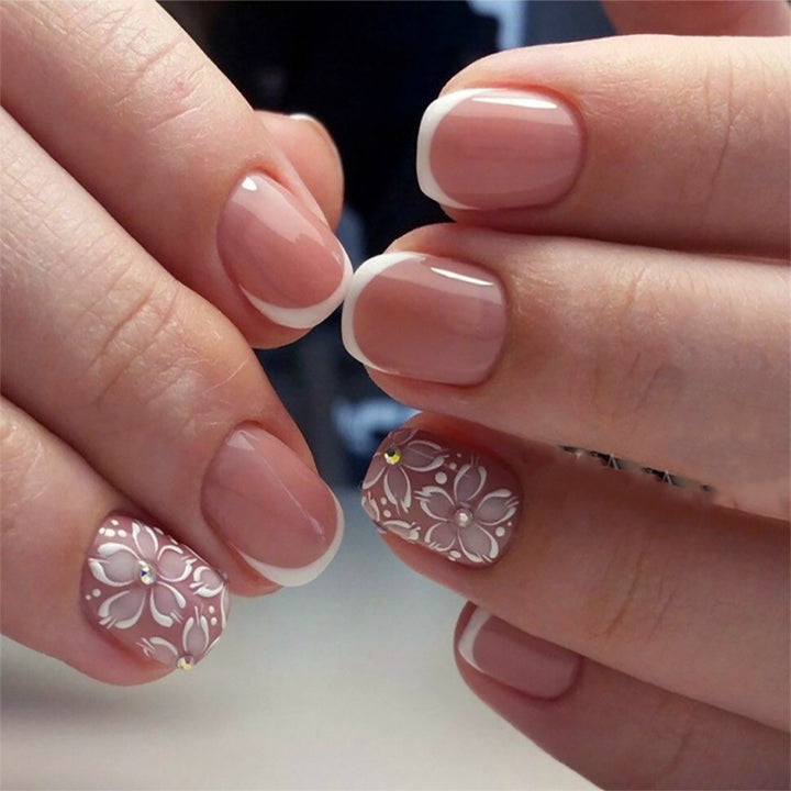 Artificial nail set with elegant French design and floral accents Stornfield