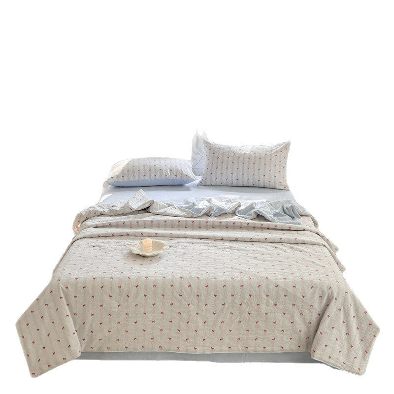 Quilt set in quilted cotton muslin with reversible function, delicate floral print and matching fitted sheet