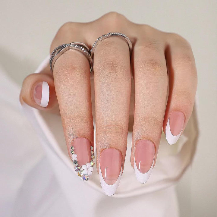 Artificial nails with elegant French tips and rhinestone details Stornfield