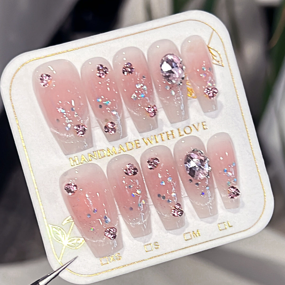 Artificial nail extensions with artistic glitter accents Stornfield