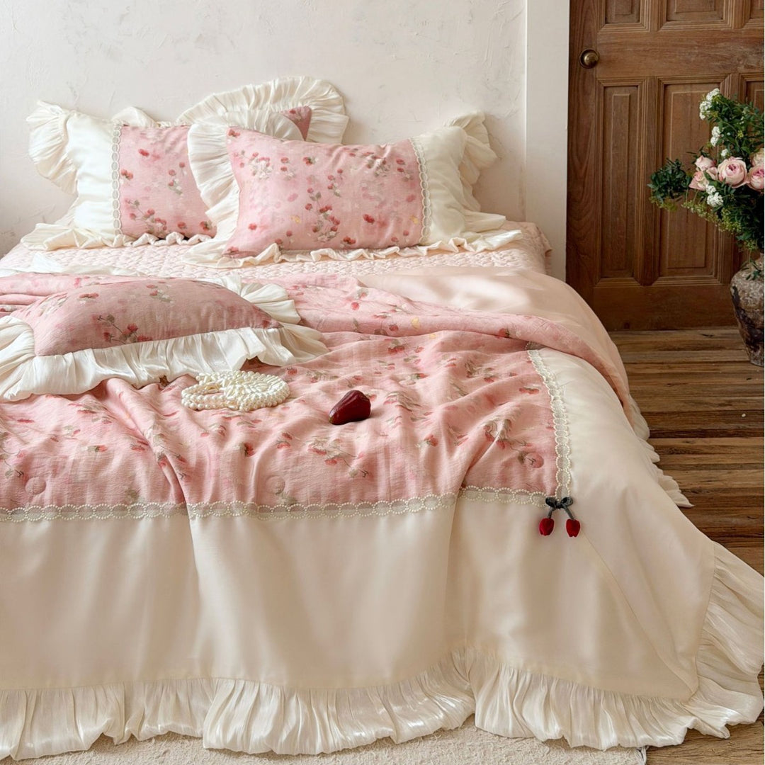 Romantic bedding set with ruffles, quilted bedspread, and decorative pillowcases