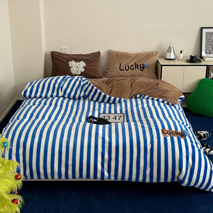 Striped reversible bedding made of microfleece with plush back and animal embroidery