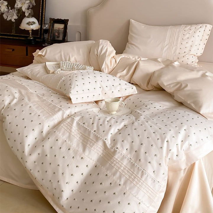 Exclusive satin bedding set with all-over rosebud embroidery and pleating details