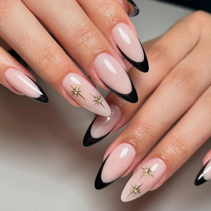 Artificial nail set with elegant black-and-white design and golden star accents Stornfield