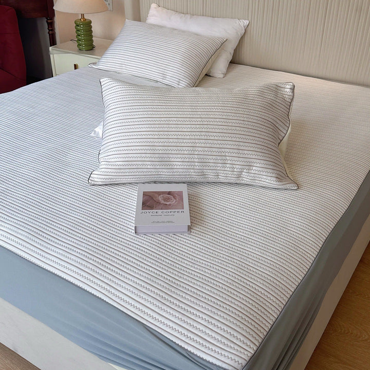 Striped fitted sheet and pillowcase set made of breathable cotton blend with fine zigzag quilting