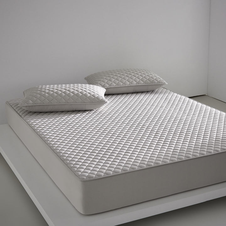 Breathable cooling mattress topper with quilted surface and elastic corner bands