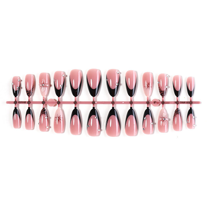 Acrylic nail set with elegant glitter and flower accents Stornfield