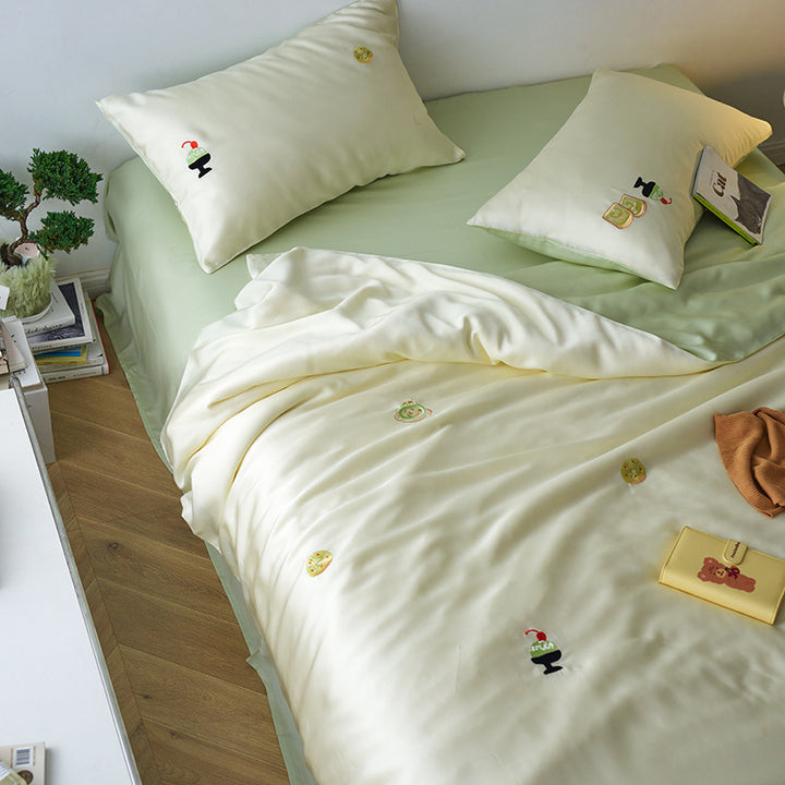 Reversible cotton satin bedding set with fitted sheet and subtle embroidery appliqués