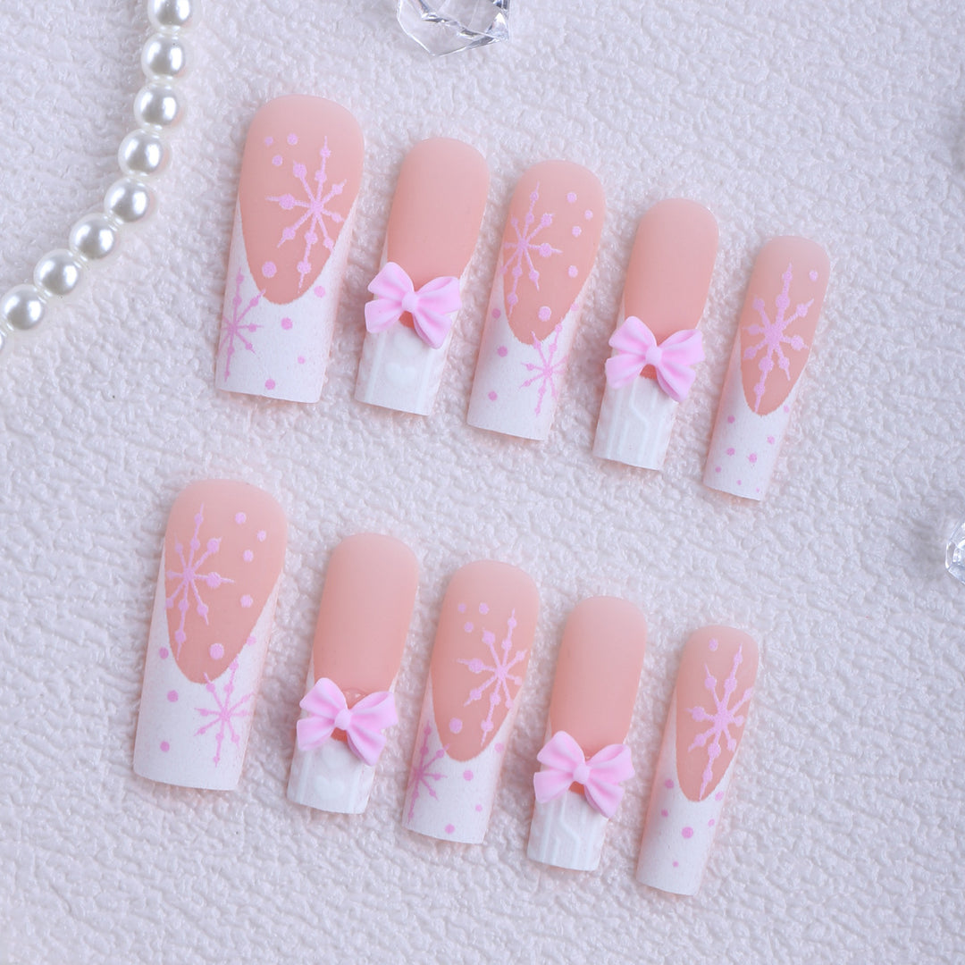 Artificial nail tips with playful bows and snowflake design Stornfield