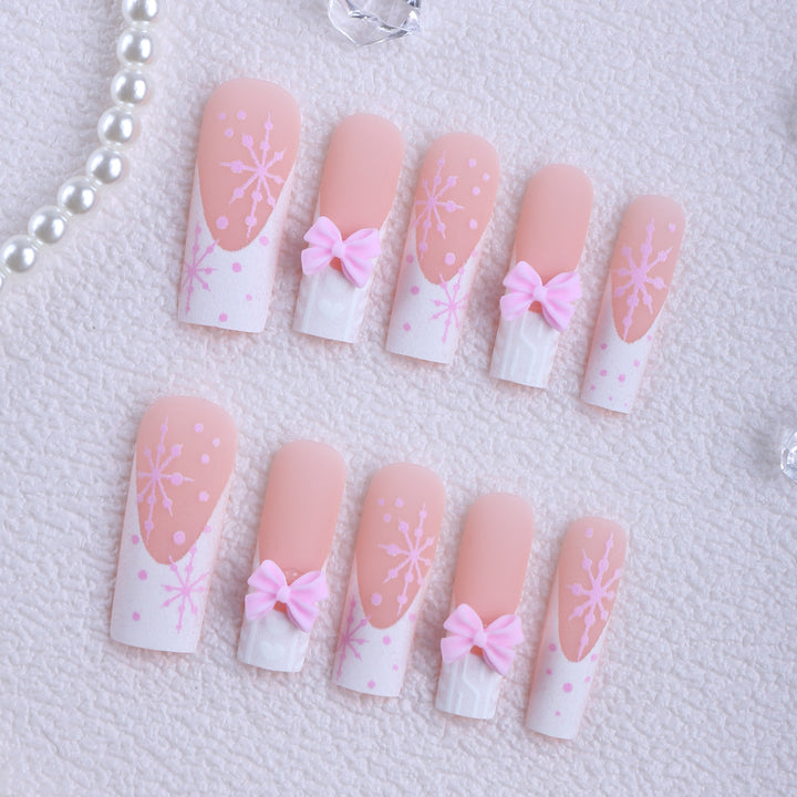 Artificial nail tips with playful bows and snowflake design Stornfield