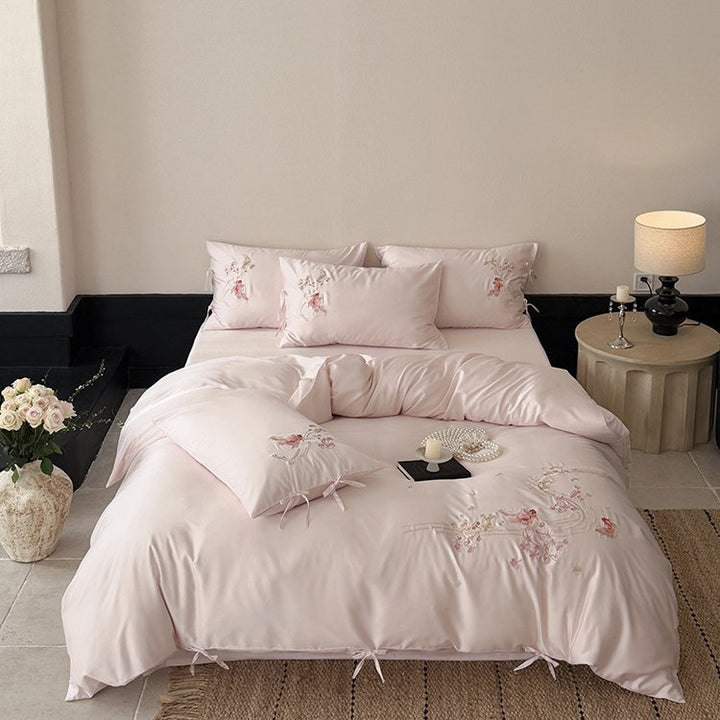 Satin bedding set with floral embroidery, ribbon ties and silky surface