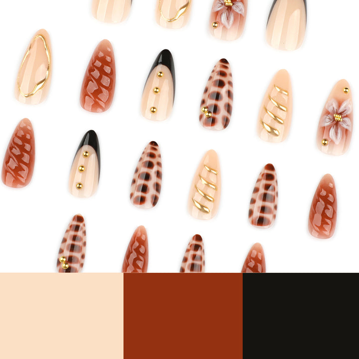 Artificial nails in modern stiletto design with golden accents Stornfield