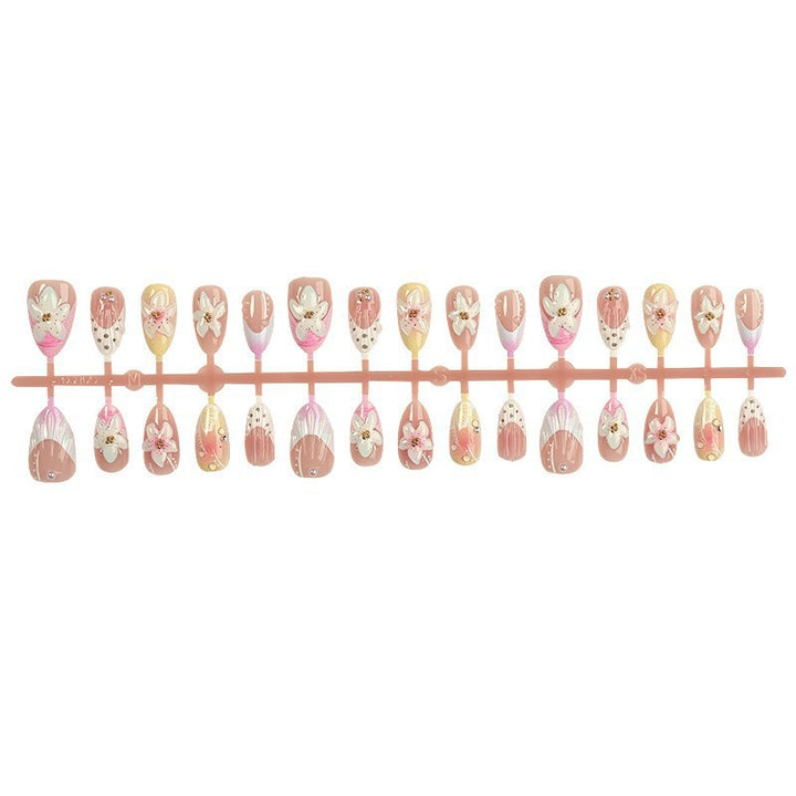 Artificial nail set with delicate floral designs and elegant accents Stornfield