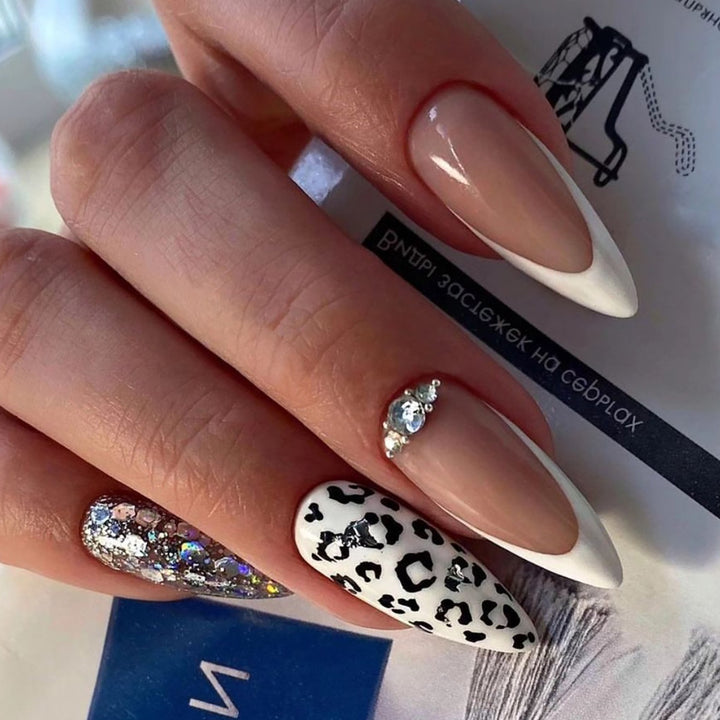 Artful stiletto nails with leopard patterns and glitter accents Stornfield