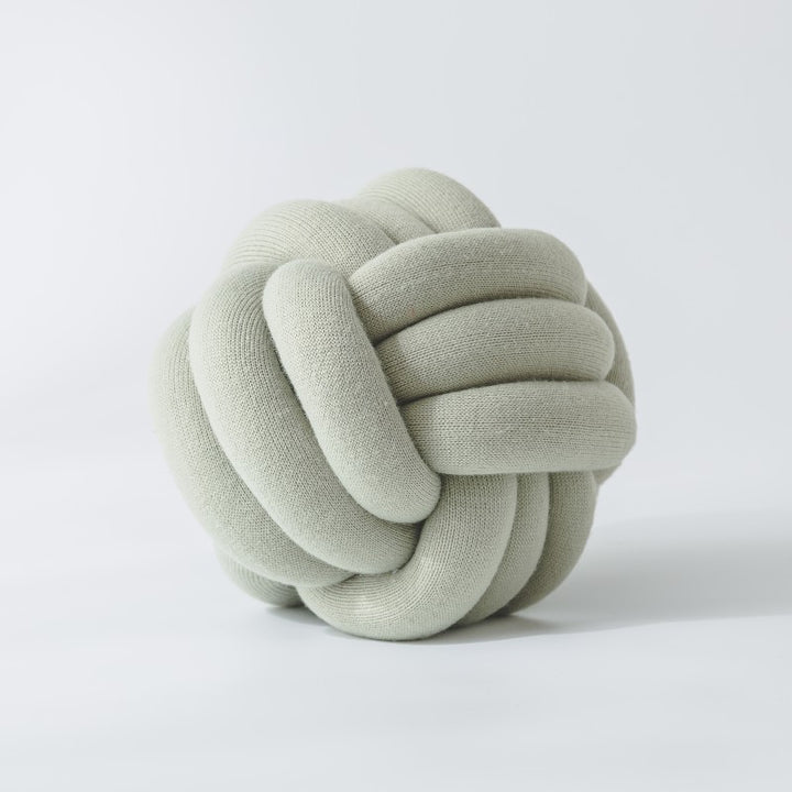 Decorative knitted knot cushion as a decorative pillow made of soft jersey
