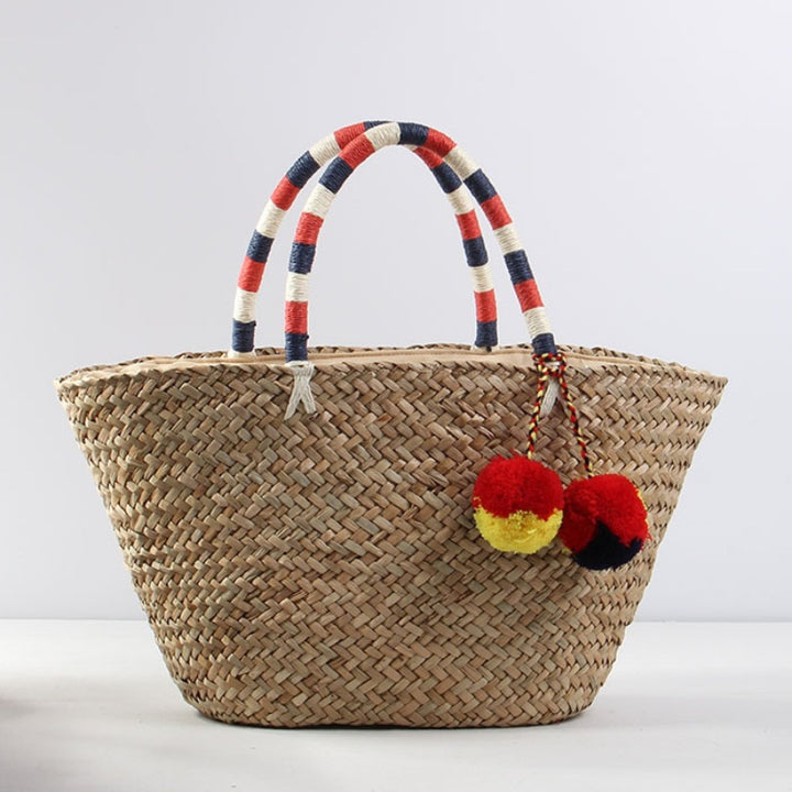 Braided beach bag with decorative pompons Stornfield