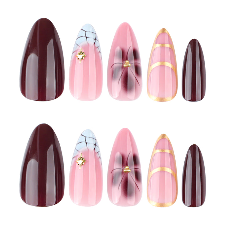 Artful Stiletto nails with gold accents and decorative floral designs Stornfield