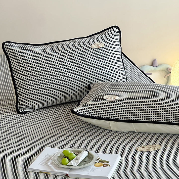 Cooling waffle structure pillow with breathable filling core and decorative piping