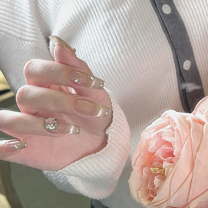 Acrylic nail set with glamorous glitter accents and elegant jewelry embellishments Stornfield