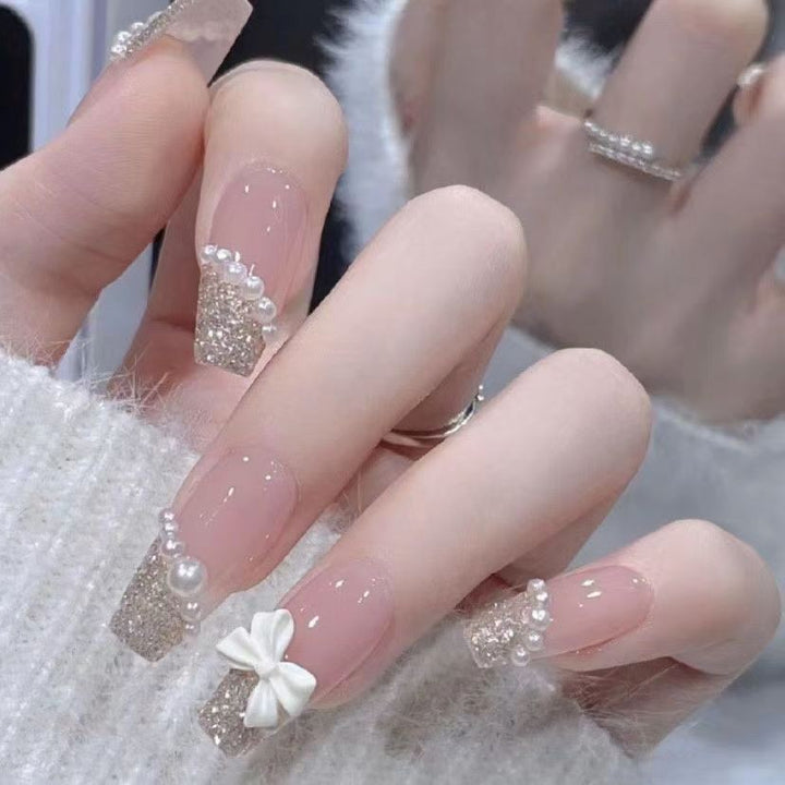 Artificial nails with glitter accents and playful motifs Stornfield