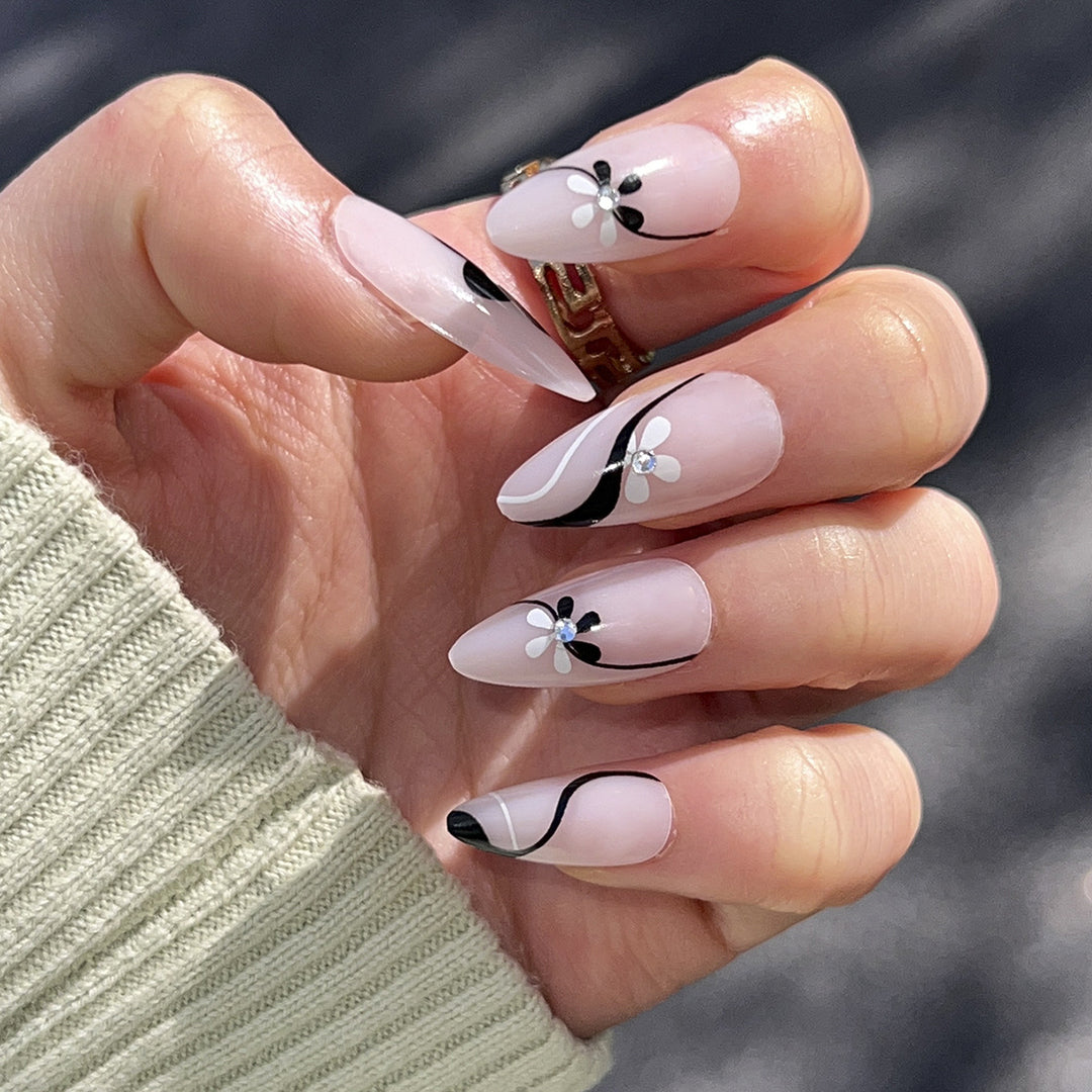 Artistic nail extensions with floral accents and glitter accents Stornfield