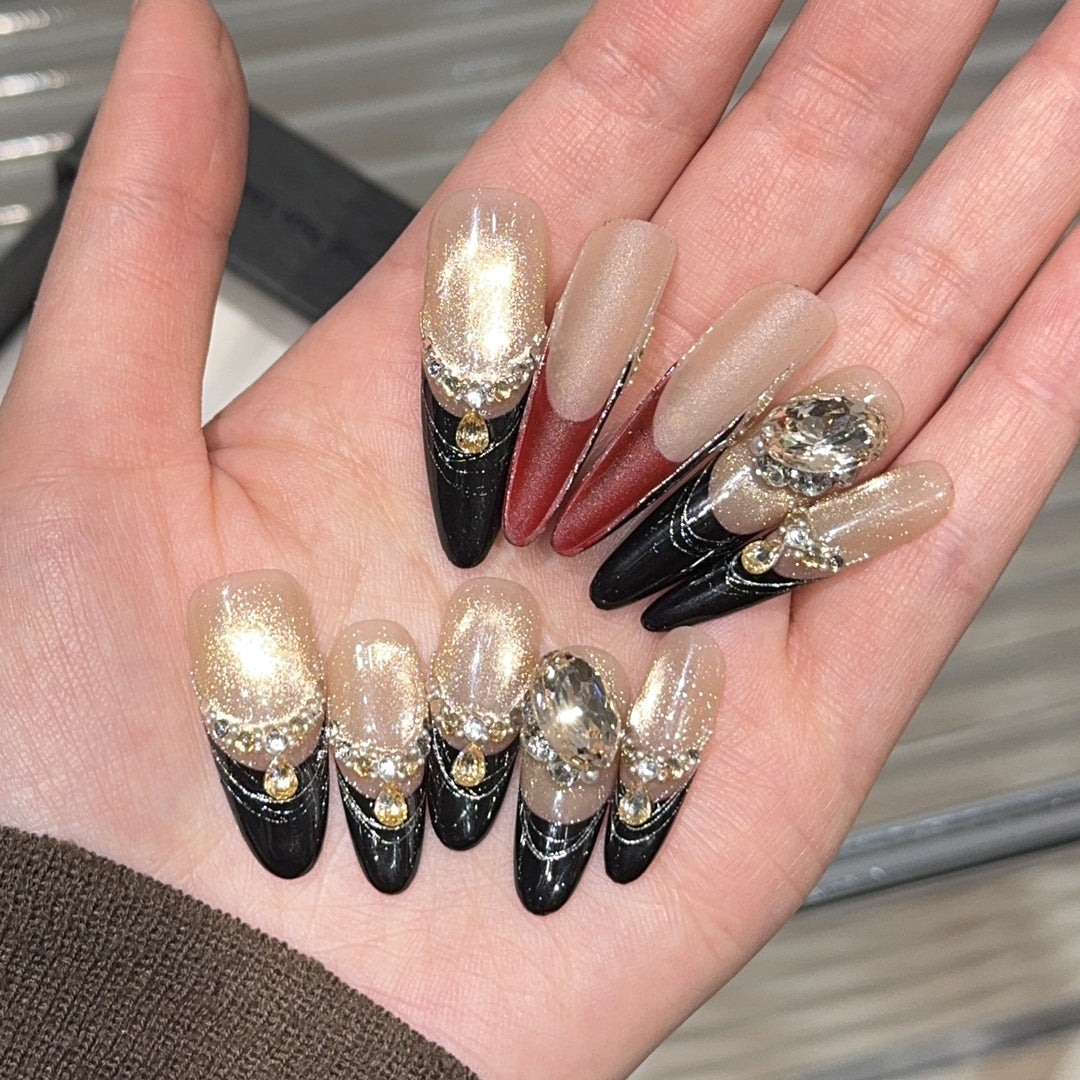 Glamorous artificial nails with extravagant rhinestone and glitter insets Stornfield