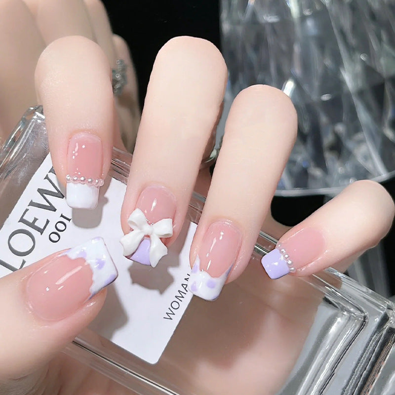 Nail art set with elegant wave patterns and delicate pearl accents Stornfield