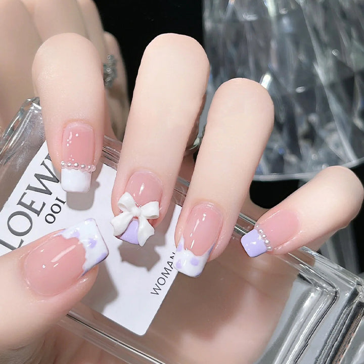 Nail art set with elegant wave patterns and delicate pearl accents Stornfield