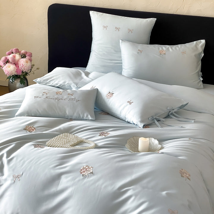 Cotton satin bedding set with delicate bow and flower embroidery as well as pillowcases