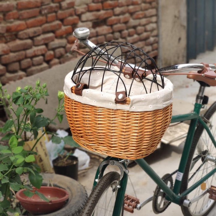 woven rattan pet carrier basket with detachable linen liner and foldable metal safety dome Stornfield