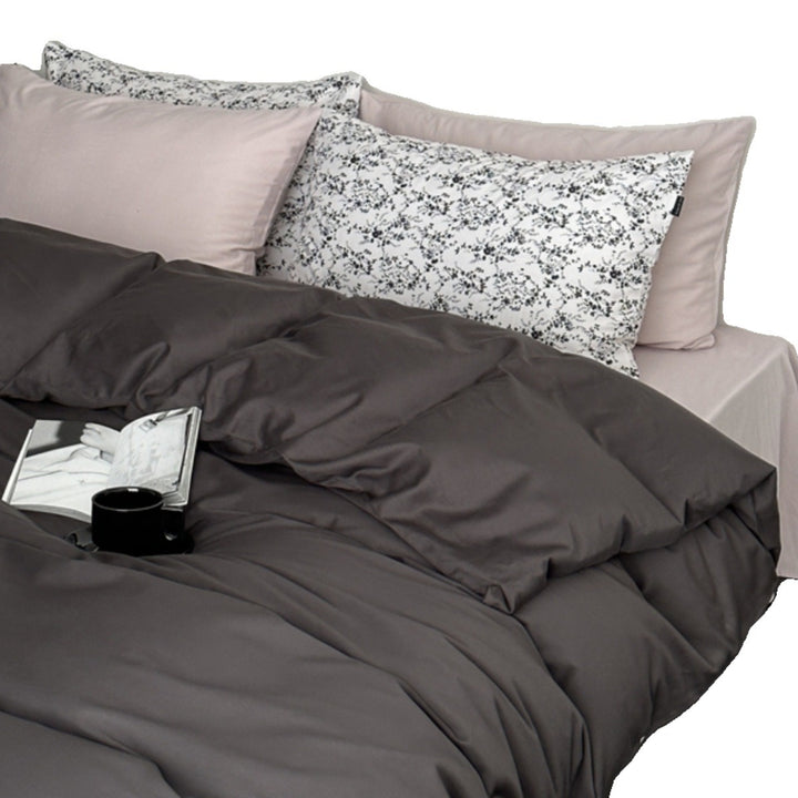 Modern satin bedding set with quilted look and patterned pillowcases